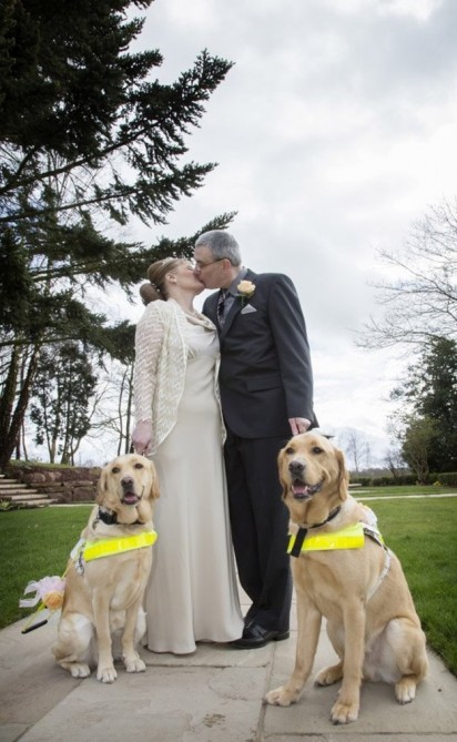 Momento em que o casal se beija carinhosamente junto dos seus fiéis cachorros. (Foto:The Guide Dogs For the Blind Association)
