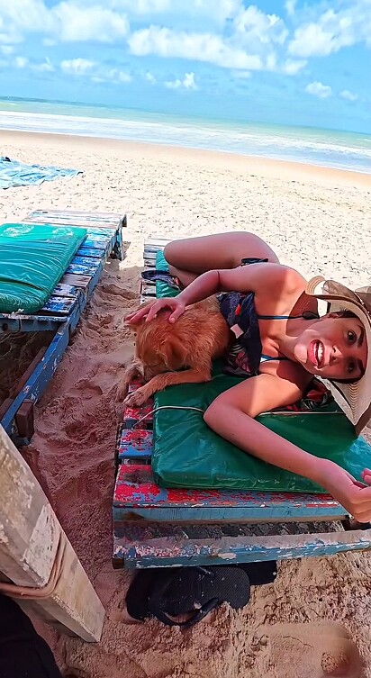 Júlia Jane estava na praia com seu marido quando viu um cachorro sozinho.