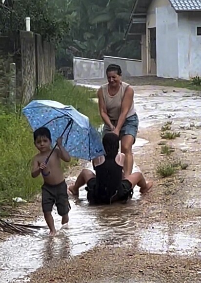 A família se divertindo na chuva.